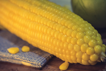 Vintage image of Golden sweet corn boil vegetable on wood