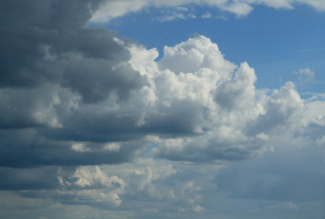 Quaint clouds in the sky. Clouds before the rain and after. The play of light and shadow