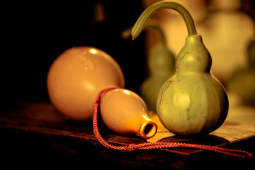 Vintage image and soft light of  fresh calabash  and Stone calabash amulet on wood