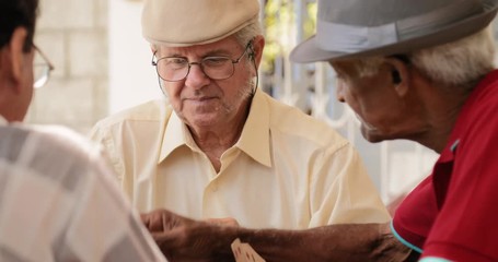 Happy Old Friends Smiling Laughing Playing Cards At Home - Powered by Adobe