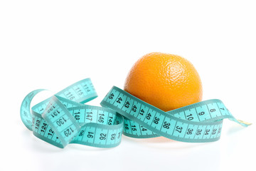 Concept of healthy diet food with orange and measuring tape