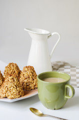 Coffee in a green mug and dessert from a shortbread in the form of a hill