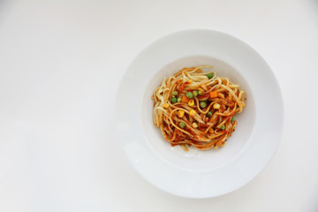 Fettuccine pasta in tomato sauce isolated in white background