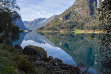 Majestic mountain peaks reflecting in mountain lake like in a mirror, Norway