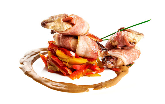 Roasted quail with saute from vegetables and sauce isolated on white background