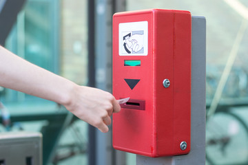 Validate a ticket at a red ticket validation machine for the underground