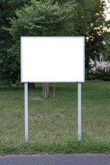 Fototapeta premium Blank ad space sign in front of trees