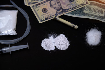 cocaine or other drugs. white powder narcotic and syringe on the table