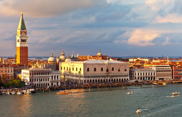 Fototapeta premium Venice. Top view of the Piazzetta San Marco, the Doge's Palace and Bell Tower Companile at sunset. Many tourists on the promenade of San Marco