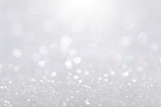 Silver and white bokeh lights defocused. abstract background