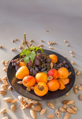 Fruit plate with grapes, apricot and almond.
