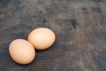 Chicken egg on wooden background with copy space
