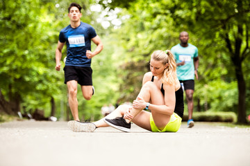 Young woman at the competition with sprained ankle.