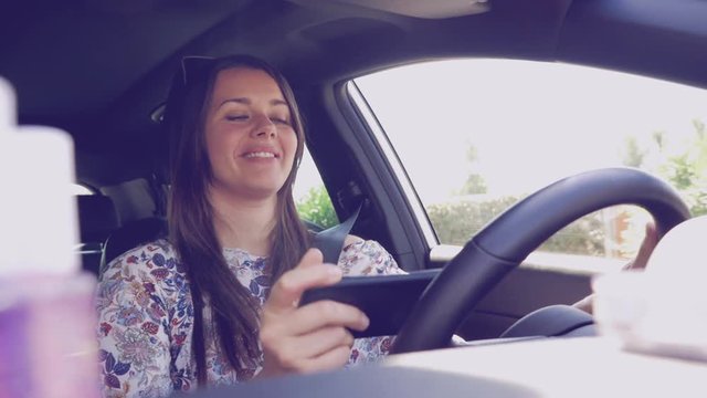 Woman having fun taking selfie while driving car dangerous