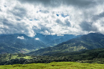 Clouds gather around valleys in rural valleys outside of Salento, Colombia.