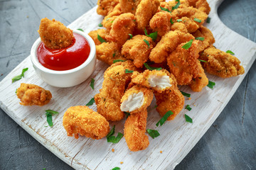 Fototapeta Fried crispy chicken nuggets with ketchup on white board obraz