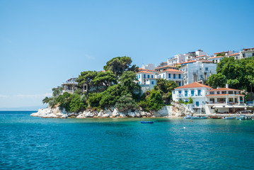 White house with blue windows on the island of Skiathos, a feature of Greek culture