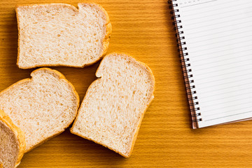 peanut butter and breakfast on wood table with book