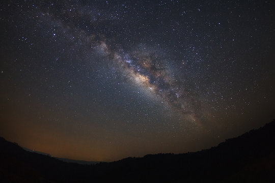 Milky way galaxy over moutain at Phu Hin Rong Kla National Park,Phitsanulok Thailand, Long exposure photograph.with grain
