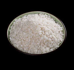 White rice in a bowl isolated on black background