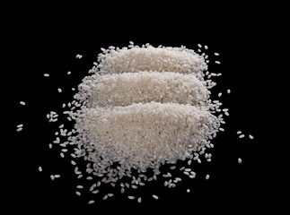 Fototapeta na wymiar White rice pile isolated on a black background