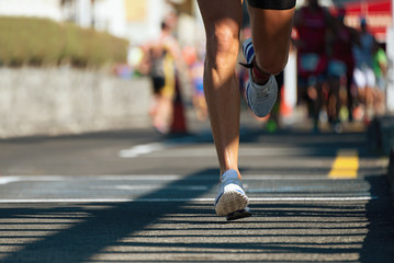 Marathon running race, people feet on city road