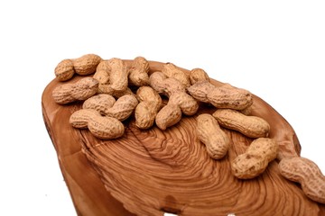 Peanuts in a shell on a wooden board isolated on a white background