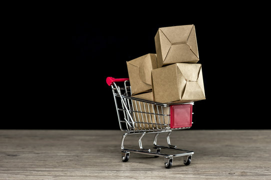 Close up shot of four carton packages in shopping trolley