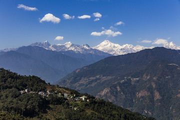 Fototapeta na wymiar Kangchenjunga mountain with clouds above and mountain's villages that view in the morning in Sikkim, India