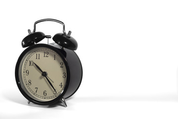 Black, vintage alarm clock with qwhite background