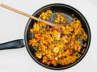 high angle view of paella in pan on table - ready to eat spanish food made from fresh ingredients in home conditions, home made organic lunch or dinner