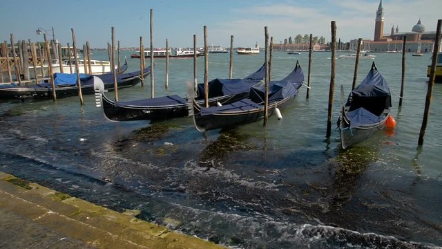 April 2017 - Gondolas and view to Chiesa di San Giorgio Maggiore Church of San Giorgio Maggiore and Fondazione Giorgio Cini right before the sunset in Venice, Italy