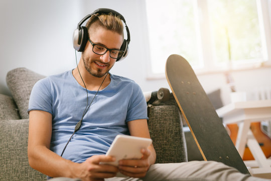 Man Listening Music On Tablet At His Home