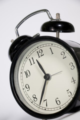 Black, vintage alarm clock with qwhite background