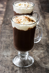 Irish coffee in glass on wooden background

