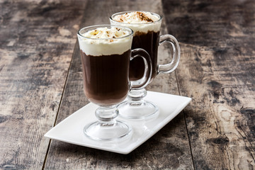 Irish coffee in glass on wooden background

