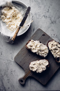 Homemade soft cheese on toasted bread, high angle view
