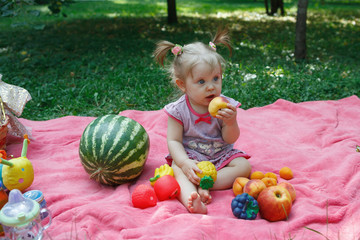 Happy family on picnic in the Park, eat watermelon, fruits