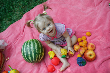 Fototapeta premium Happy family on picnic in the Park, eat watermelon, fruits