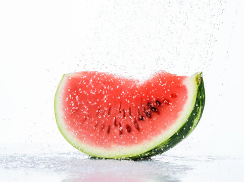 Fresh red watermelon slice with splash and drops of water
