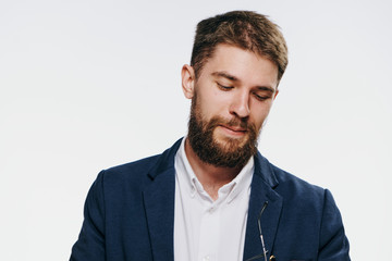 Business man looking down, business man with a beard, business man on a light background portrait