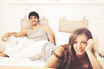 Couple laughing in bed and they are happy