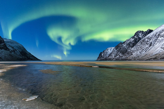 Northern lights in the night sky over Ersfjord Beach. Ersfjord, Ersfjorden, Senja, Norway, Europe.