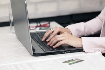 Female hand typing text on the keyboard
