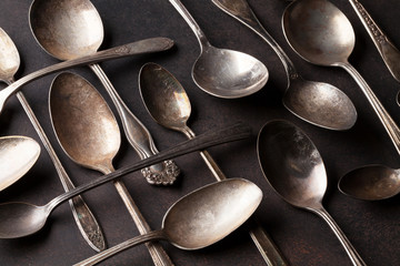 Old vintage spoons on stone table