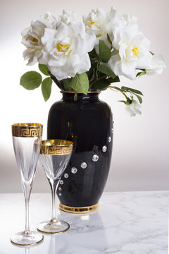 BLack  vase with flowers and glass