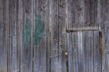 Ancient abandon aged wooden fence and door lock as background in Matera, south Italy