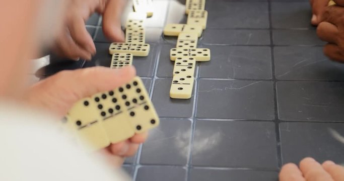 Detail Of Male Hands Playing Domino Game