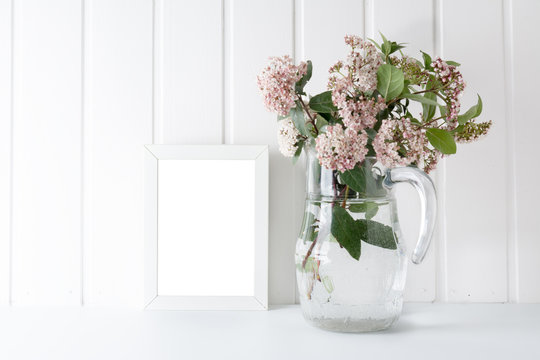 empty picture frame, decorated with Bouquet of pink natural flowers