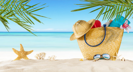 Tropical beach with accessories on sand, summer holiday background.